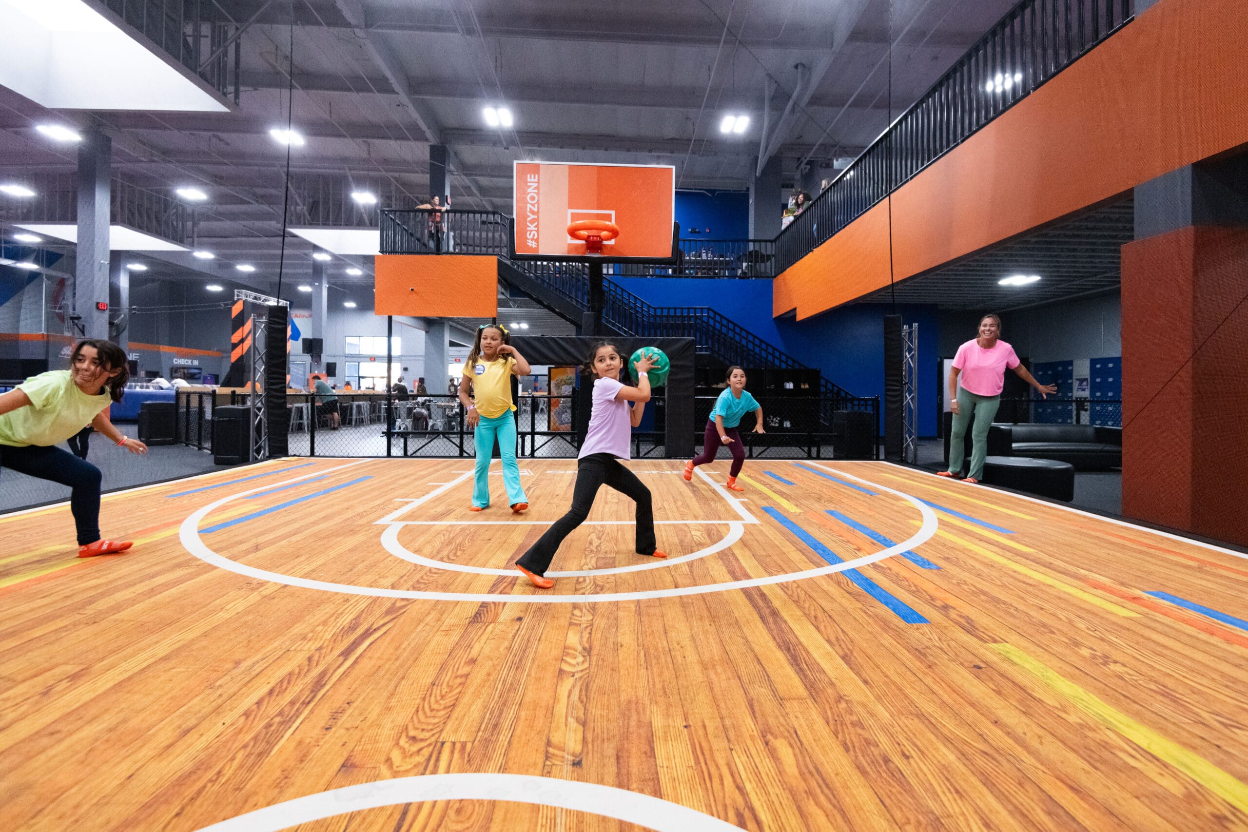 A girl and her friends playing at an indoor playground